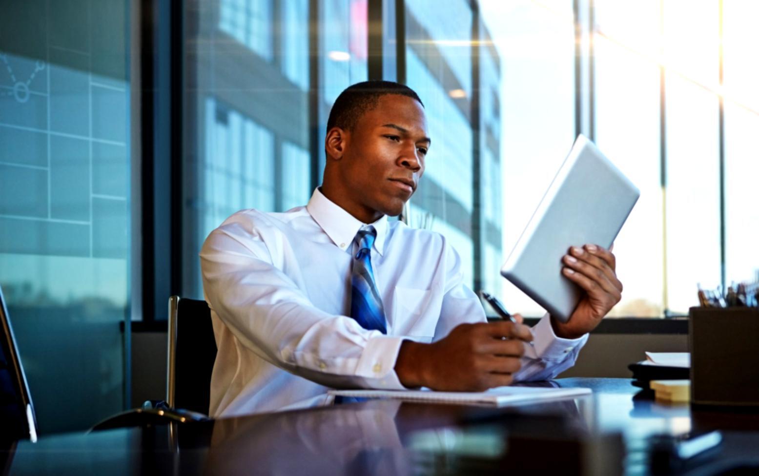 Student reviewing budget presentation materials with detailed notes